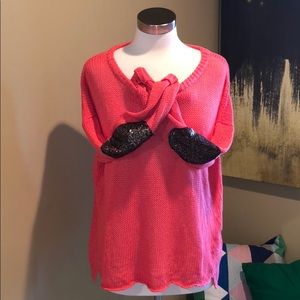 Loose knit sweater with sequin elbow patches